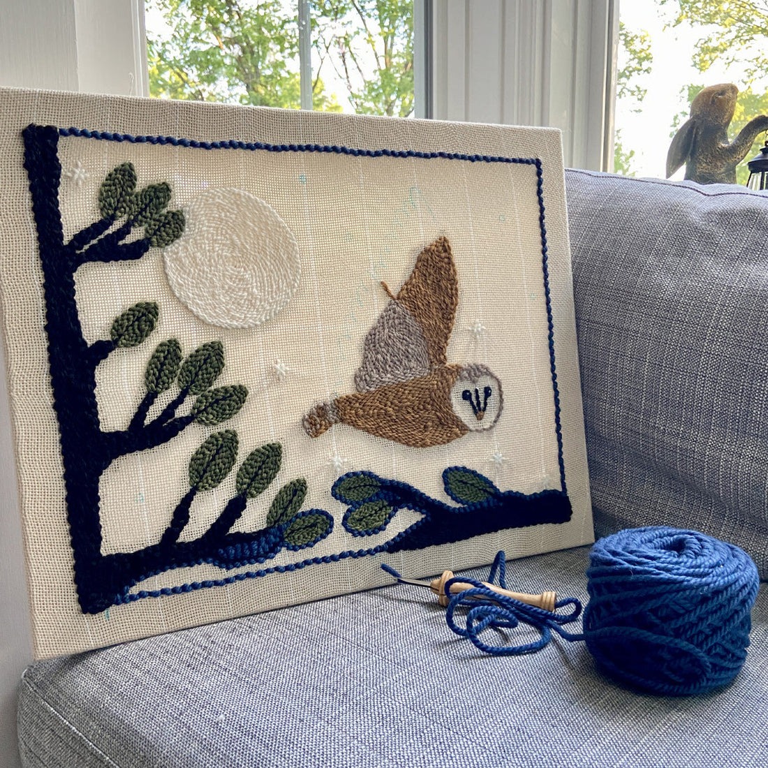 textile art of owl flying through trees and past moon. Art work in progress.