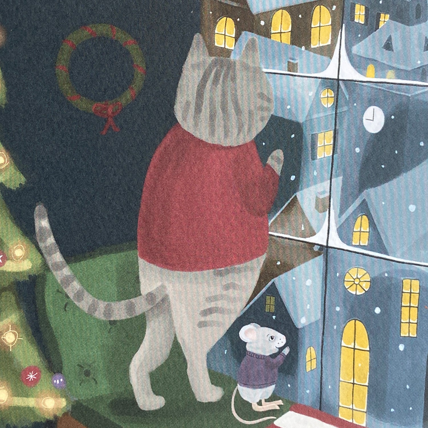 Close up iIllustration of a holiday card featuring a cat in a red sweater looking out a window with a mouse near a Christmas tree.