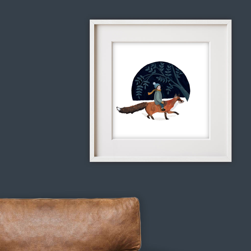 Framed artwork of a young child riding a fox with a dark blue sky and tree in the background, on a dark blue wall.