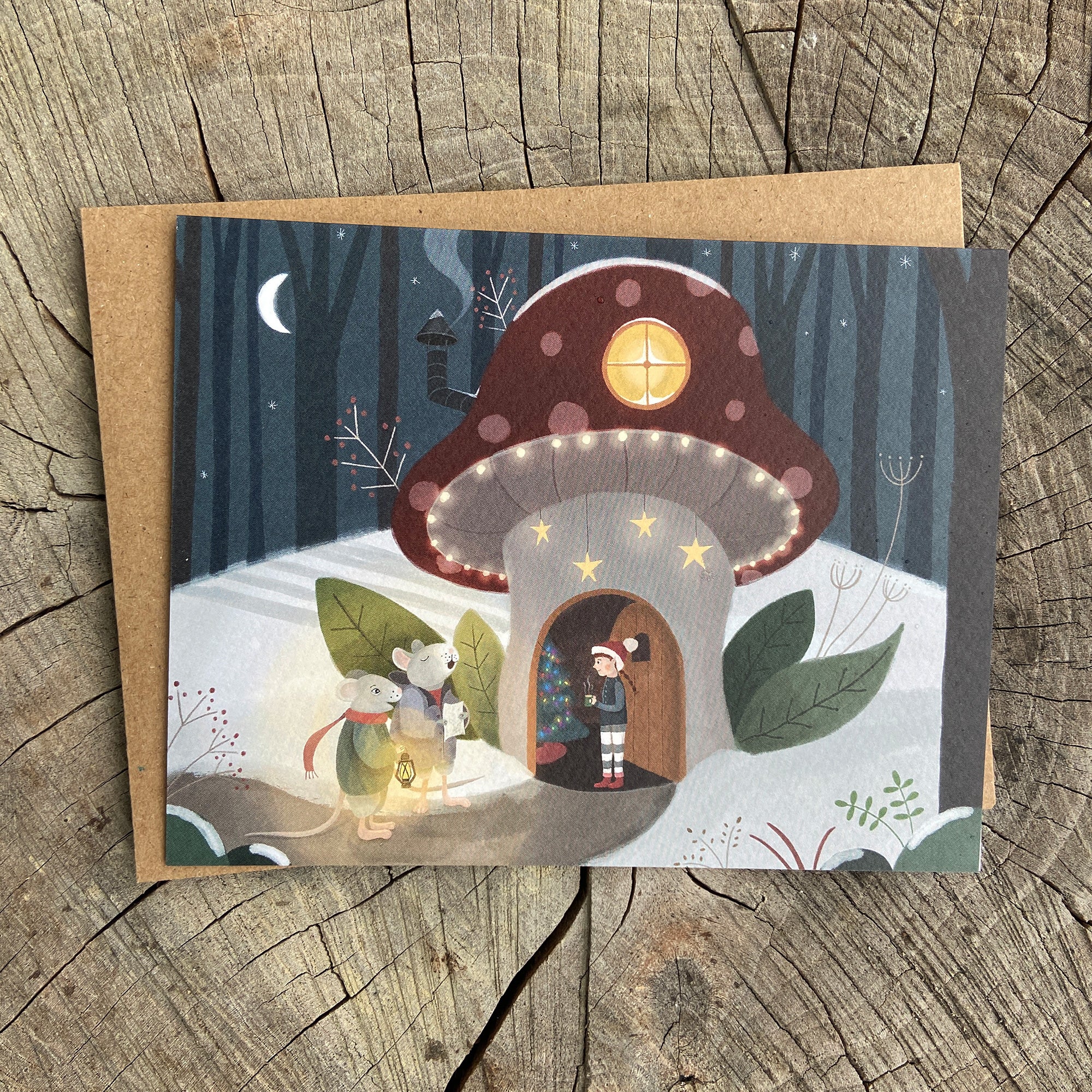 Illustrated holiday greeting card of a two mice singing Christmas carols at a fairy or gnome's mushroom house.