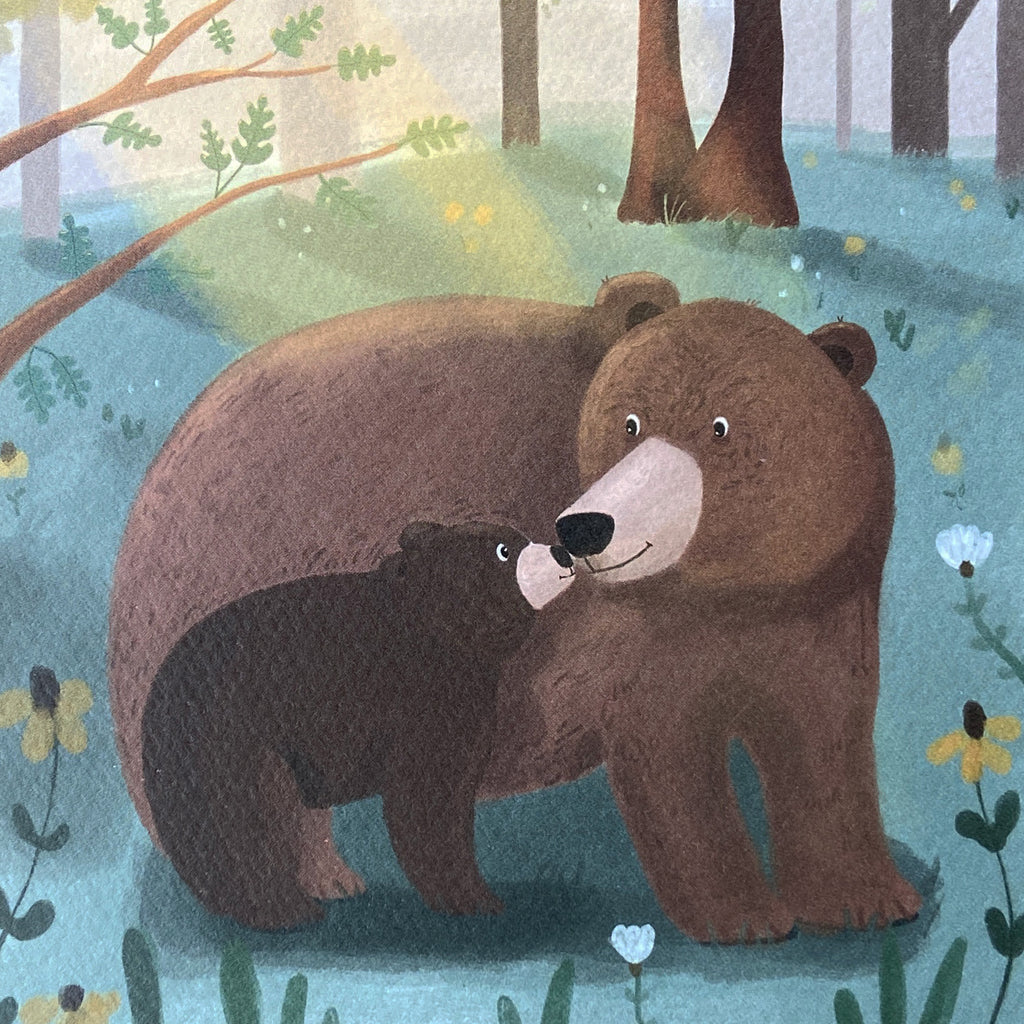 Close up of a greeting card featuring two bears in a forest setting with flowers and trees.