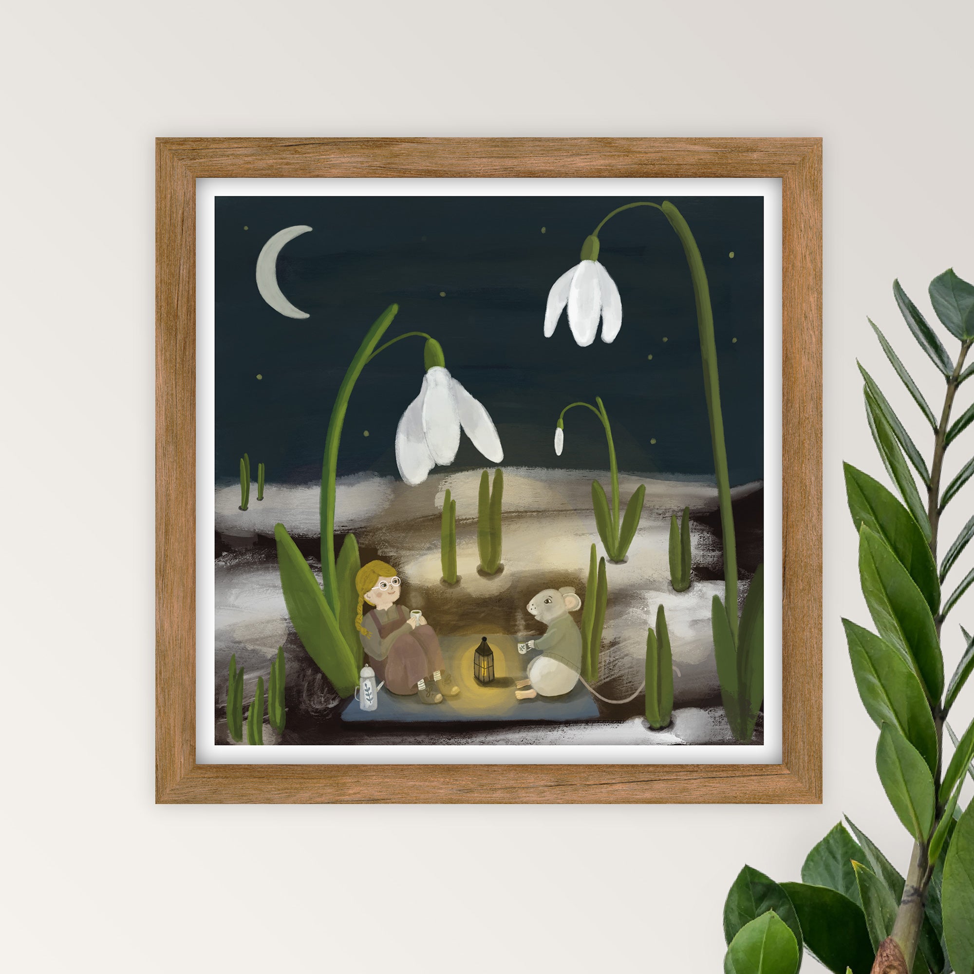 Framed artwork of a child and mouse drinking tea by snowdrop flowers under a moonlit sky.