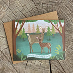 Mother's Day card with deer illustration on a wooden surface