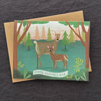 Greeting card with deer illustration and 'Happy Mother's Day' text on a dark fabric background