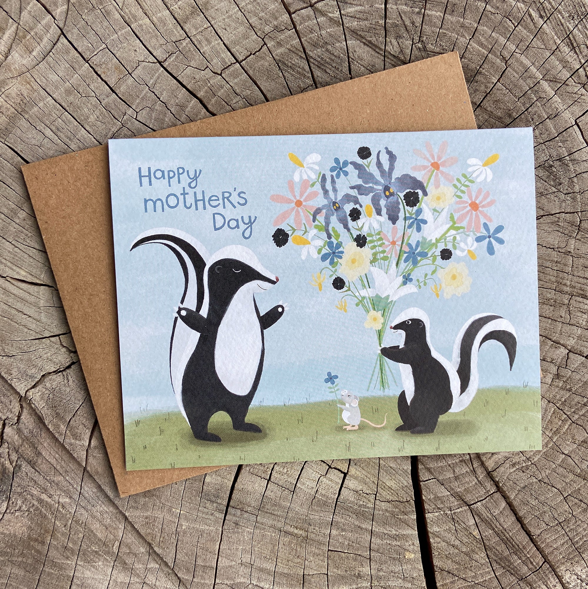 Mother's Day greeting card with baby skunk holding flowers for mom skunk.