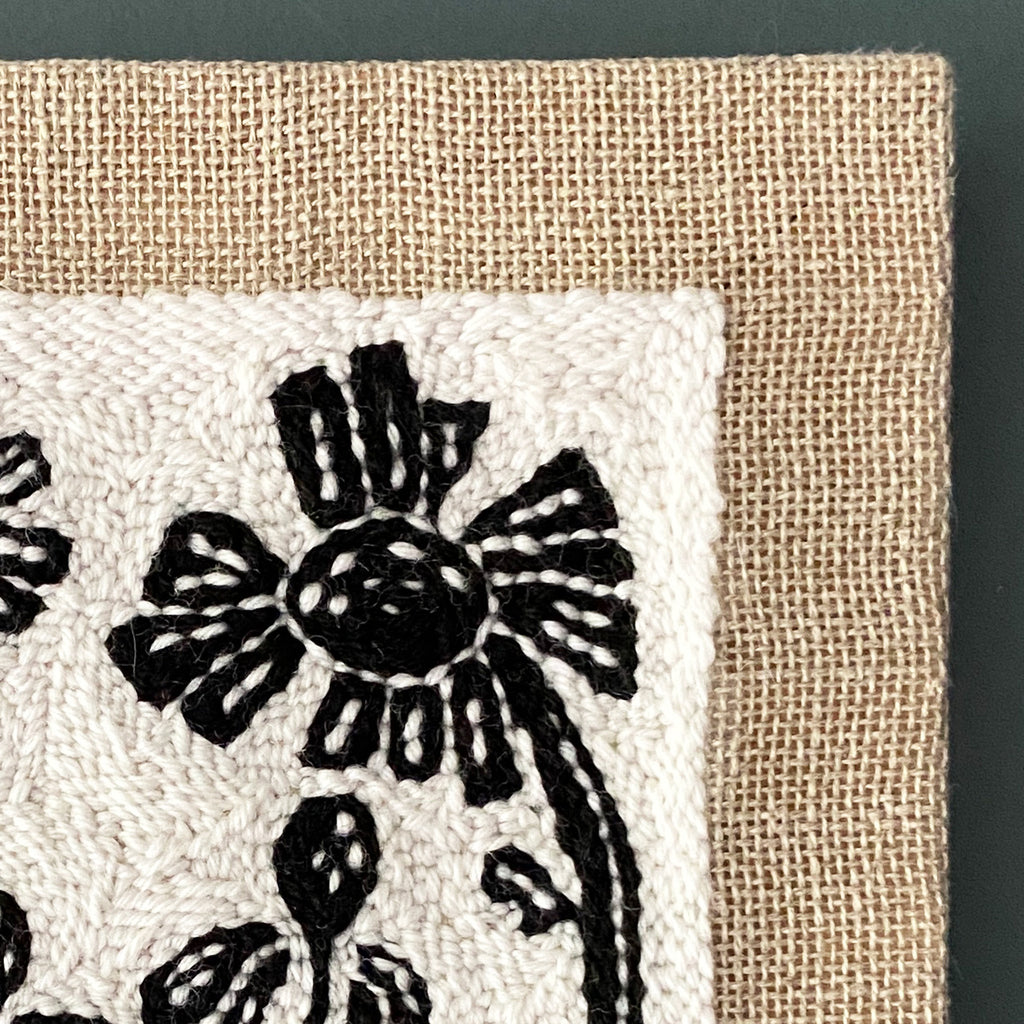 Textile with black wildflower pattern on a beige background
