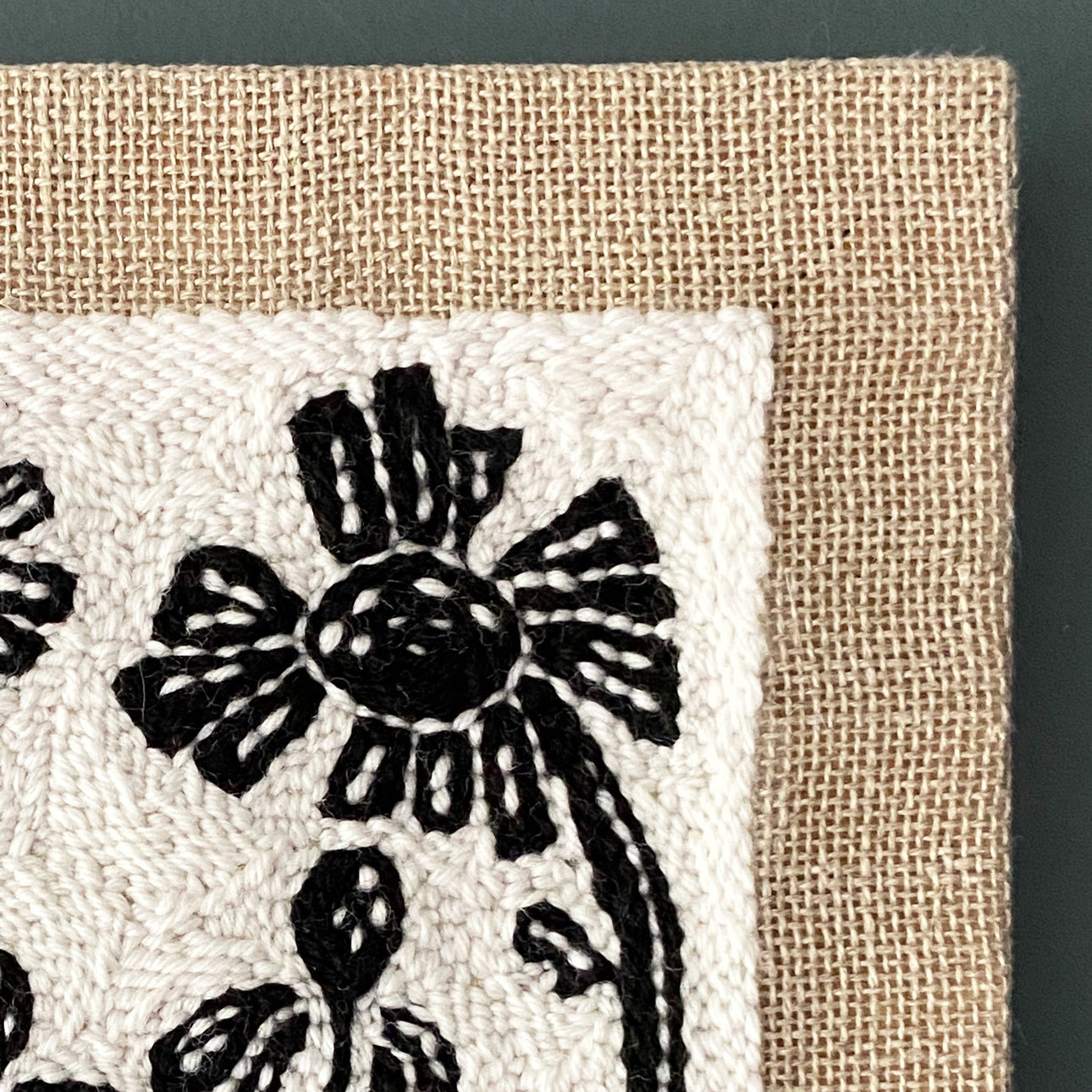 Textile with black wildflower pattern on a beige background
