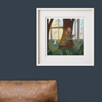 Framed illustration of a forest scene with woodland animals on a dark blue wall.