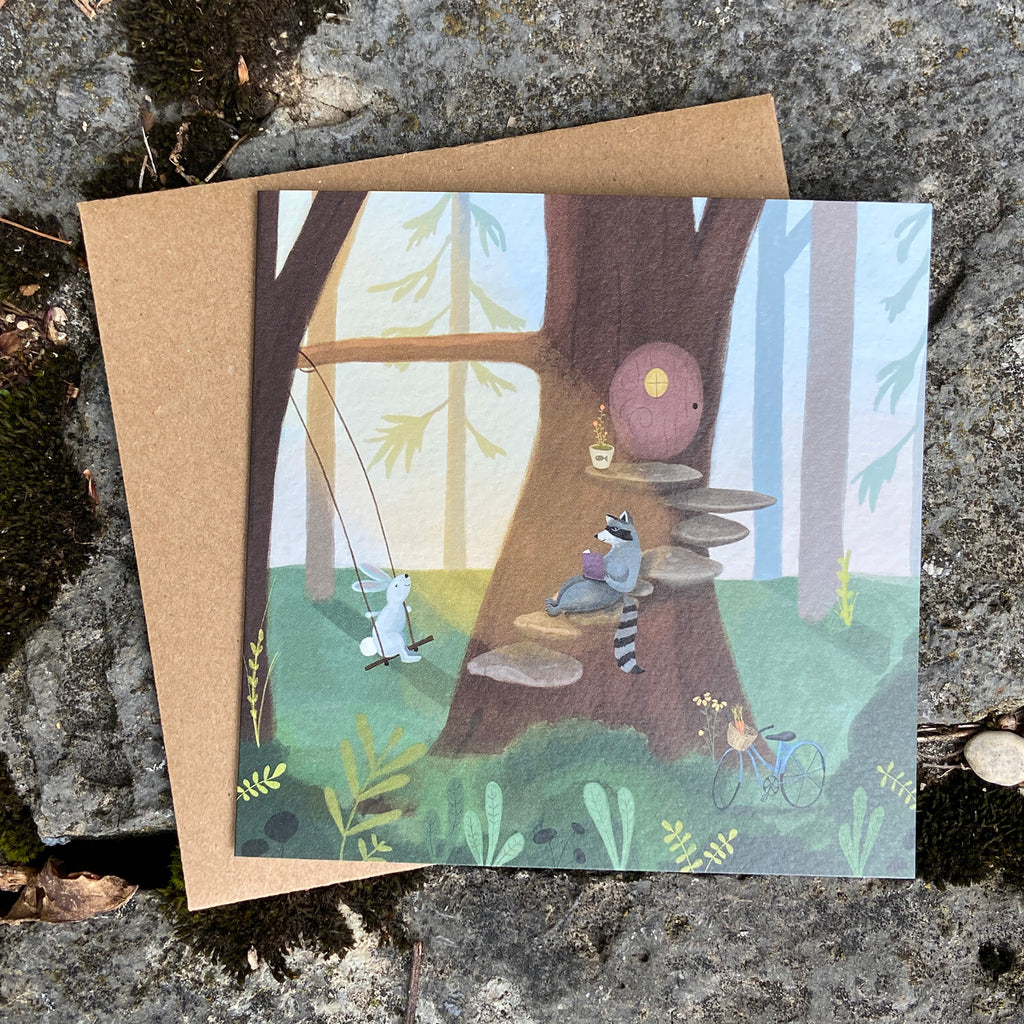Greeting card with forest scene illustration, on a textured surface