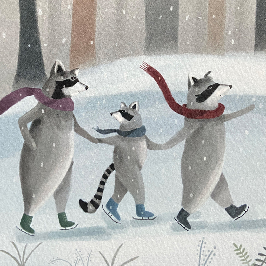 Close up of a winter greeting card featuring a raccoon family skating on ice with scarves in a snowy forest.