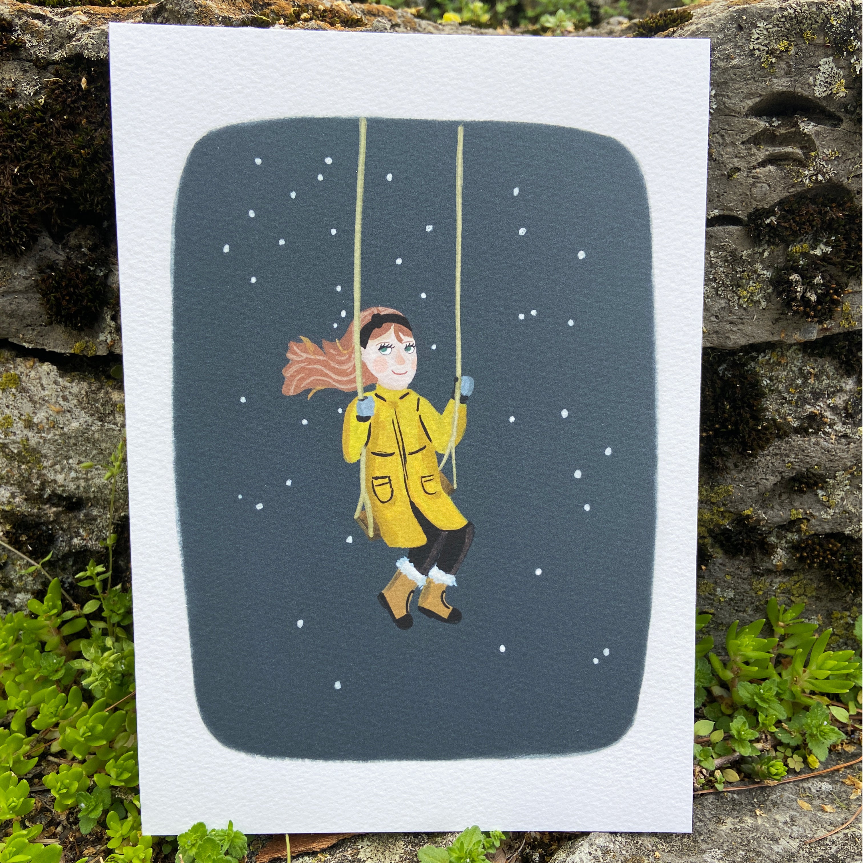 Illustration of a girl in a yellow raincoat swinging in the snow with a gray background.