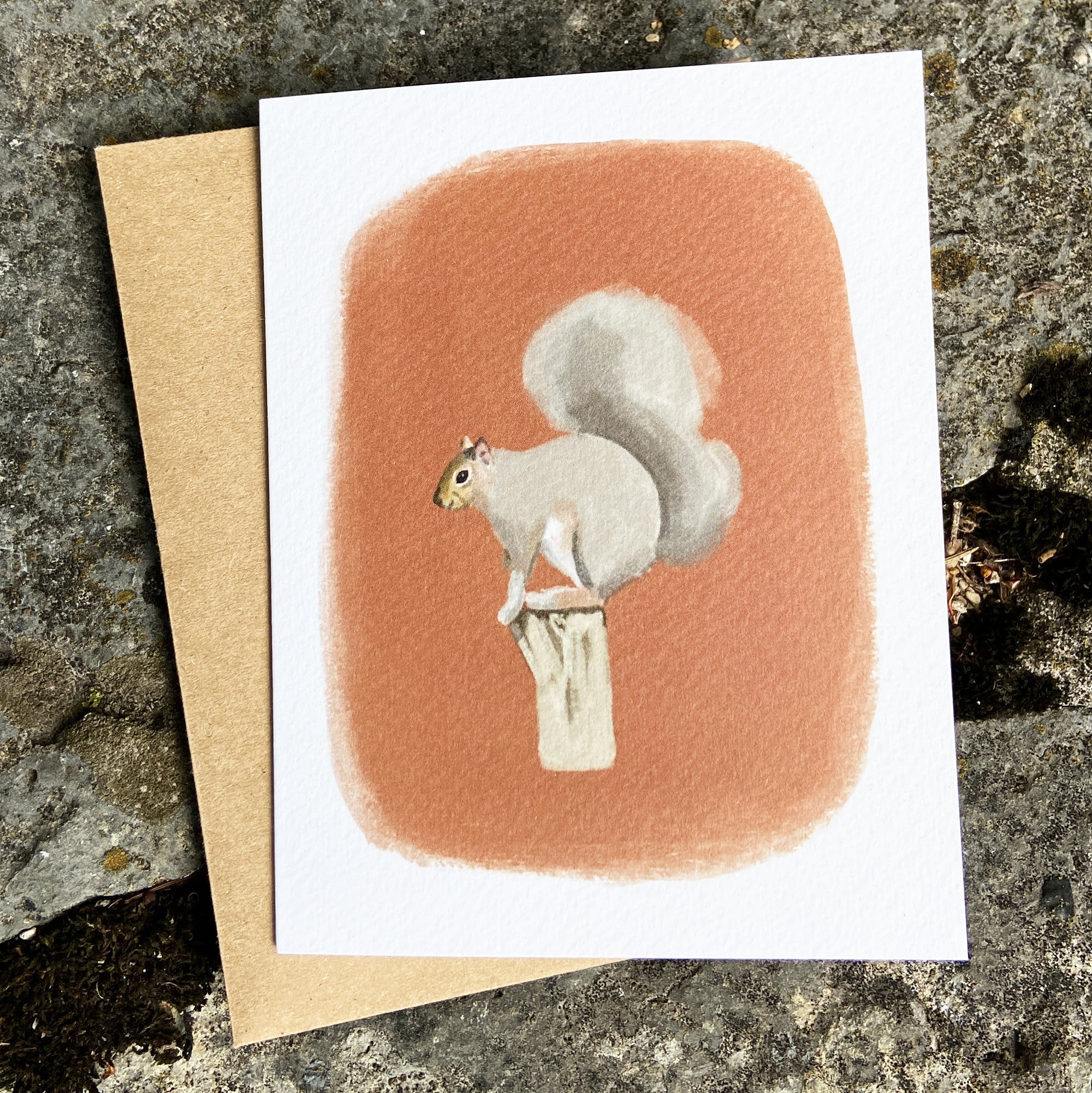 Greeting card with a squirrel illustration on a textured surface