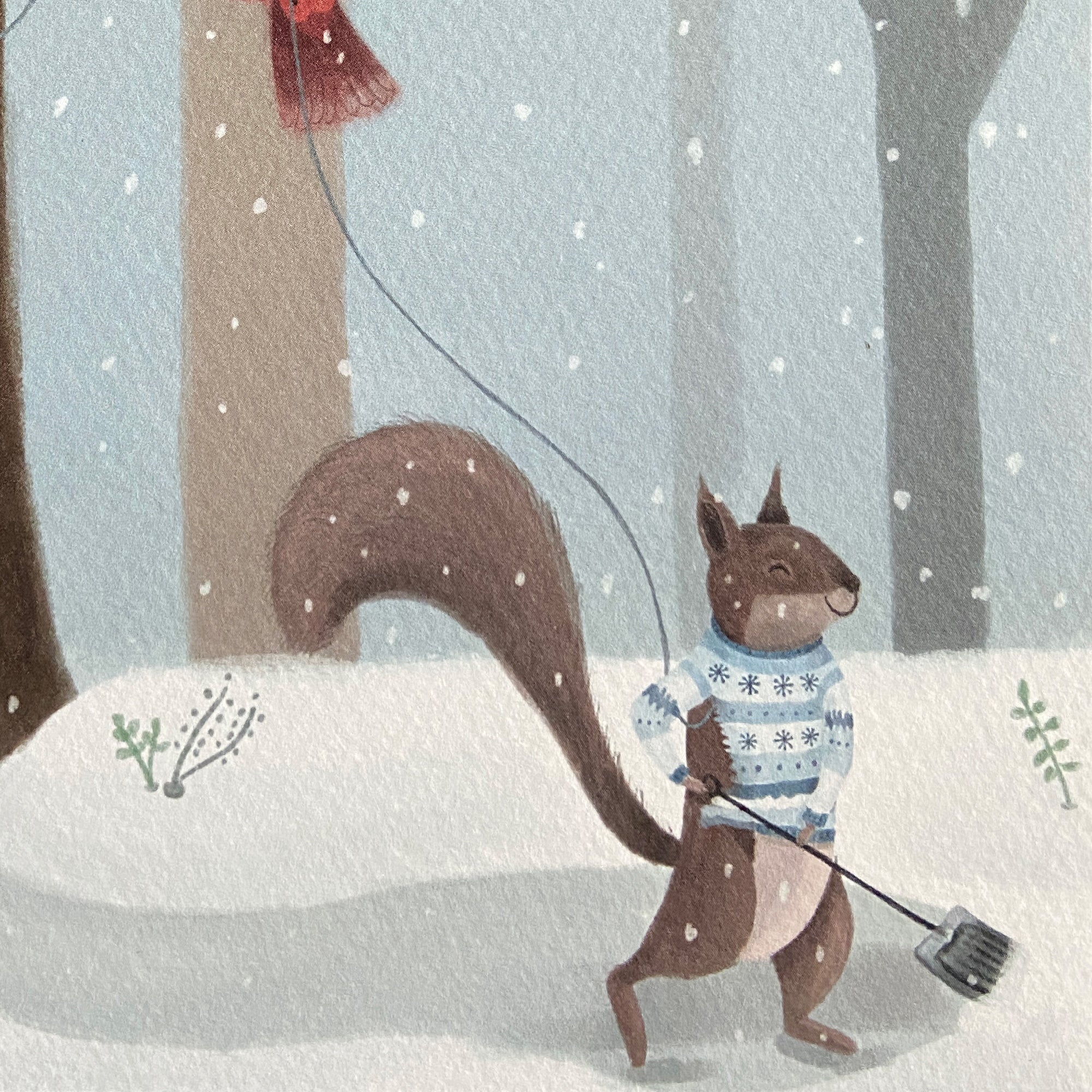 Close up Illustration of Christmas card featuring a squirrel shoveloing in a winter scene with snow and trees.