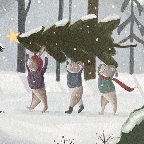 Close up Illustration of holiday greeting card featuring three rabbits carrying a Christmas tree through a snowy forest.