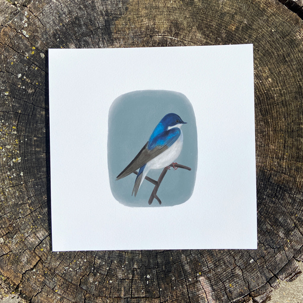Art print with a bird illustration on a wooden surface