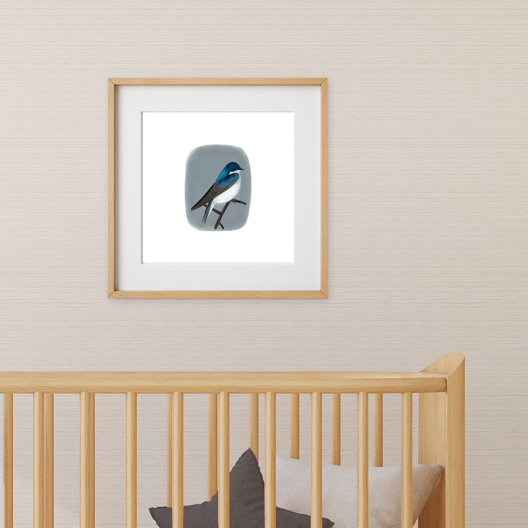 Framed artwork of a cute blue bird on a wall in a nursery