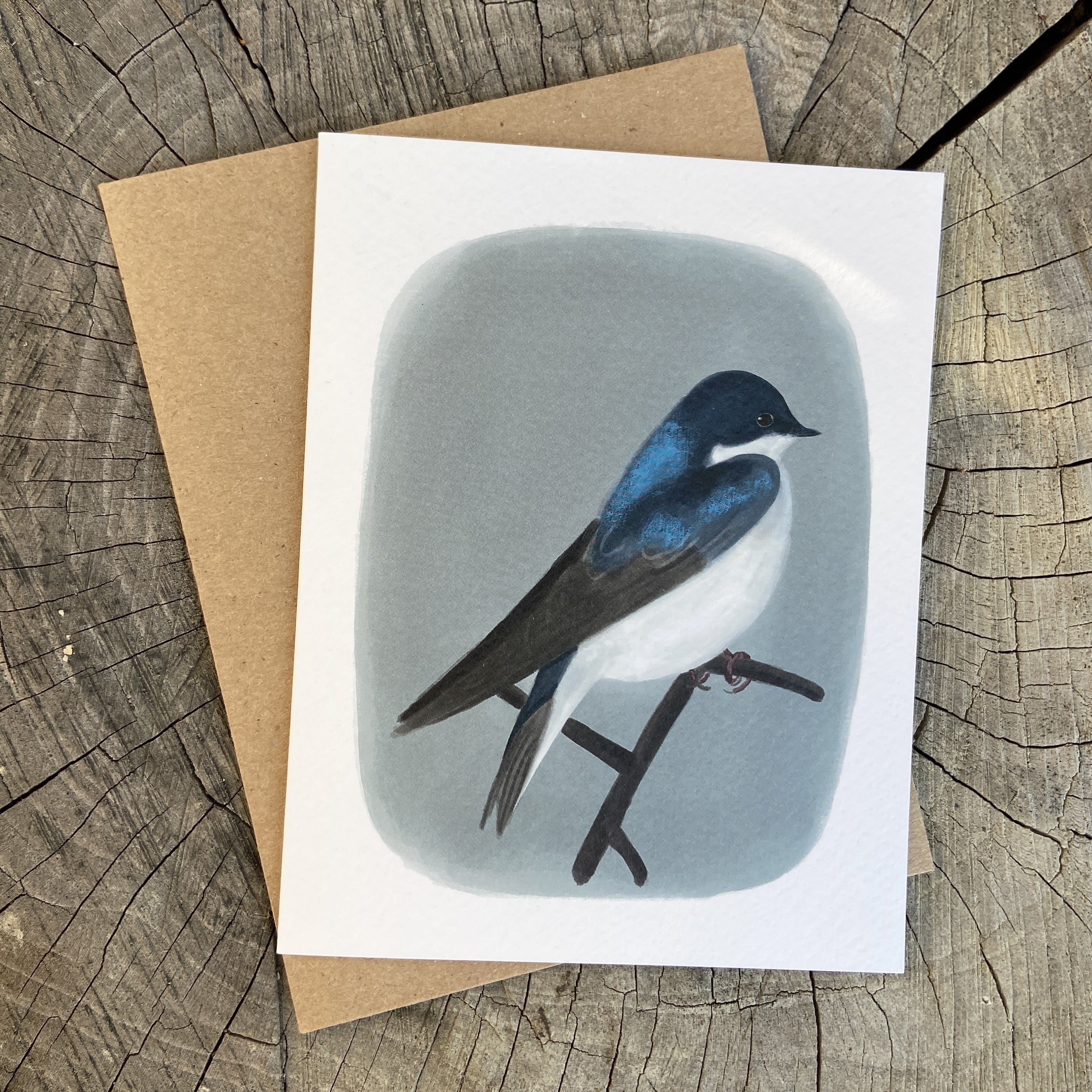 Greeting card with a bird illustration on a wooden surface