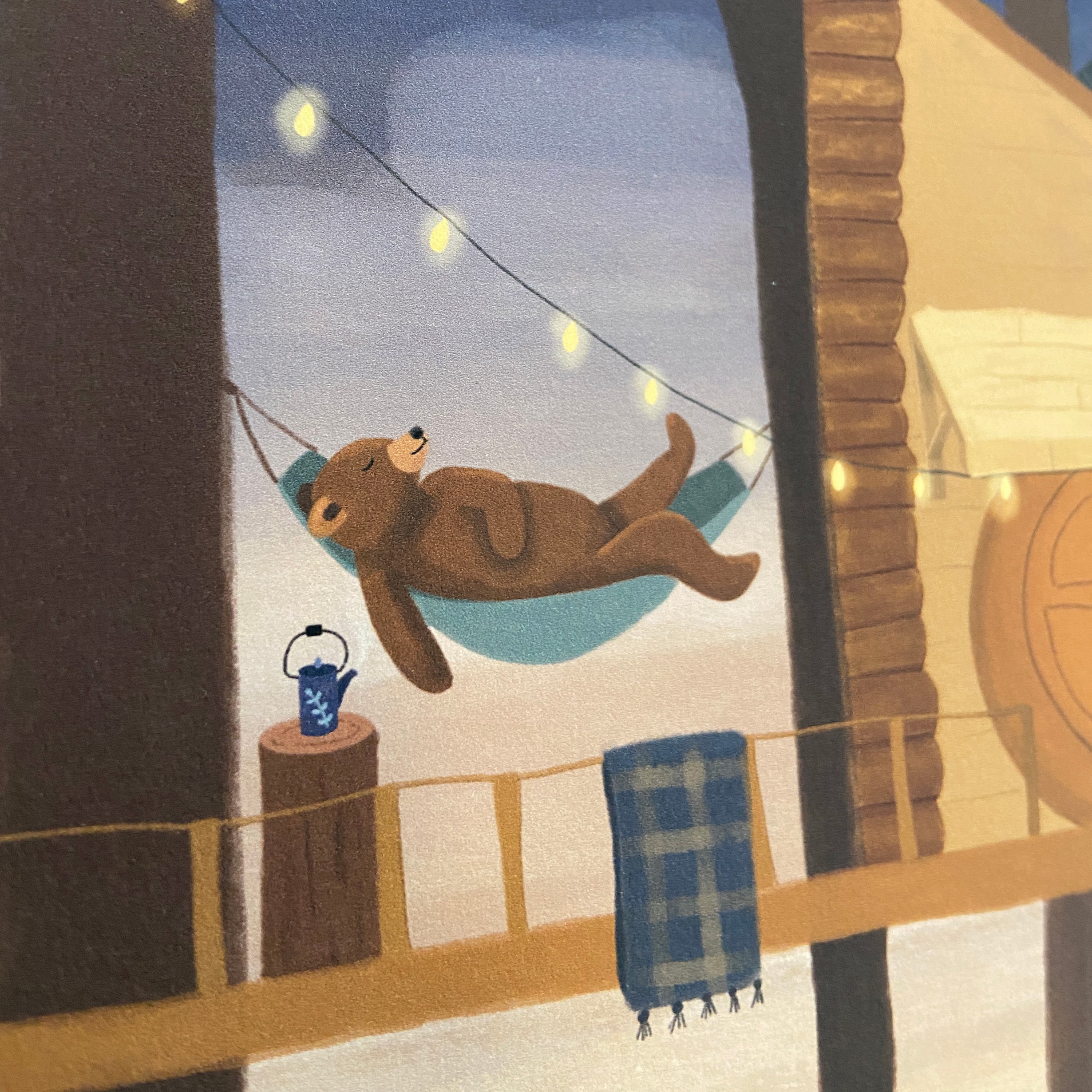 Illustration of a bear in a hammock in a treehouse with string lights and a teapot.