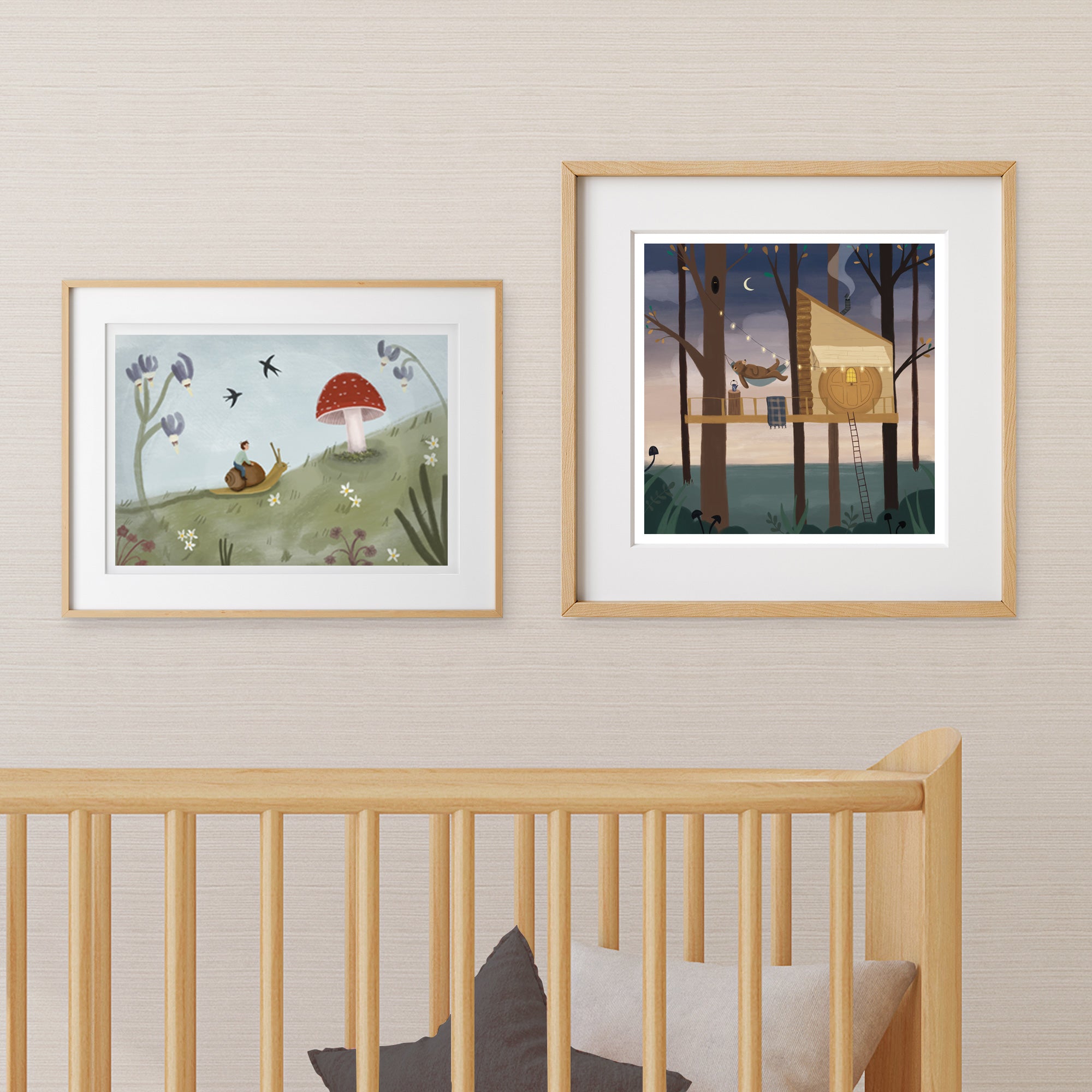 Two framed nursery artworks above a crib with a neutral wall background