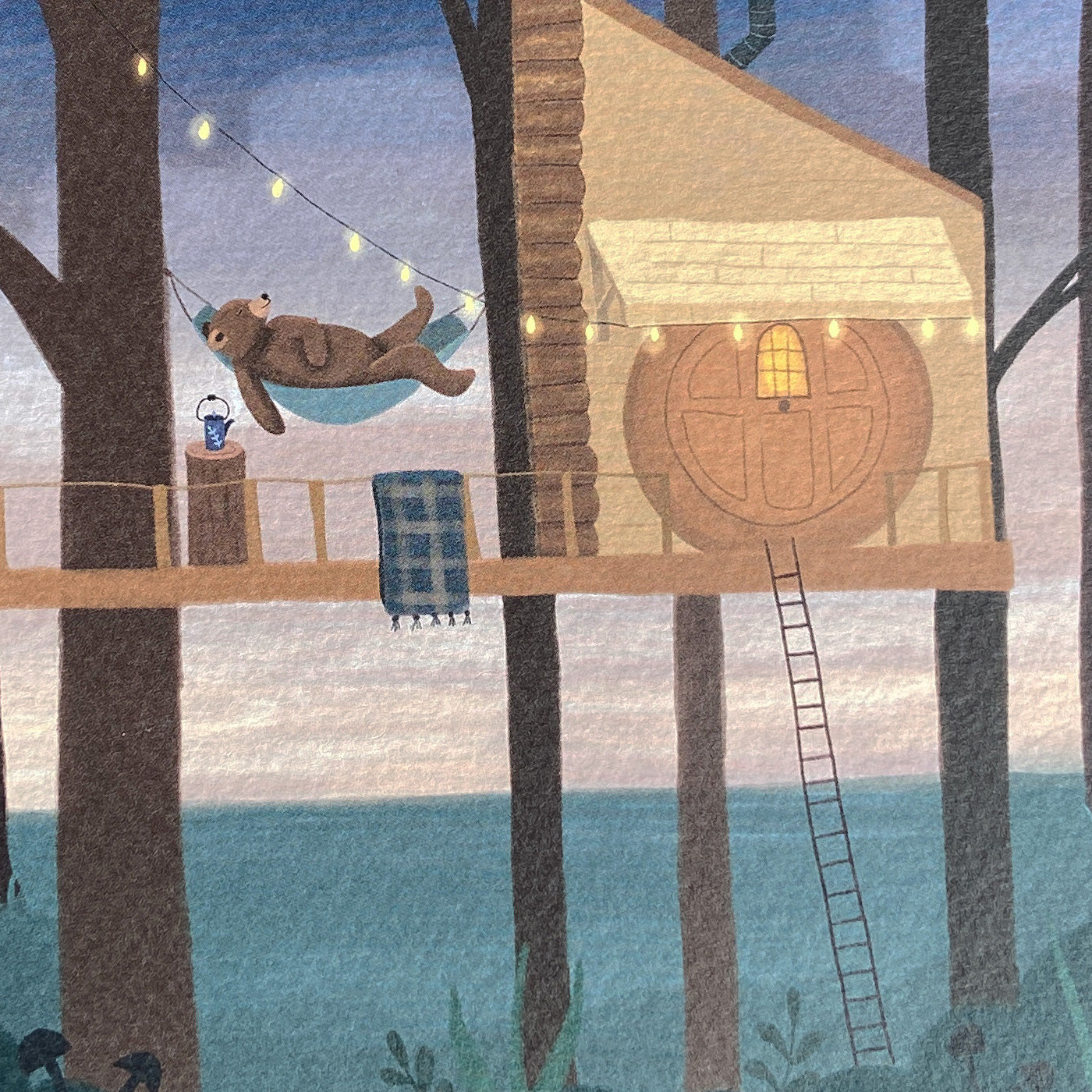 Close up greeting card illustration featuring a treehouse with a bear in a hammock in a forest setting