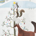 Close up of a holiday card featuring animals decorating a Christmas tree with lights and ornaments on a snowy background.