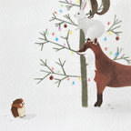 Christmas card illustration of a fox, rabbit, and owl by a decorated tree in the snow.